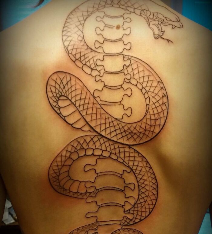Snake and back bone tattoo in progress