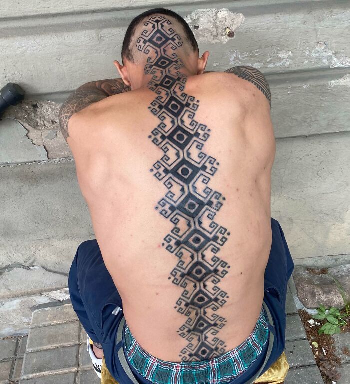 Large geometric tattoo on back and head