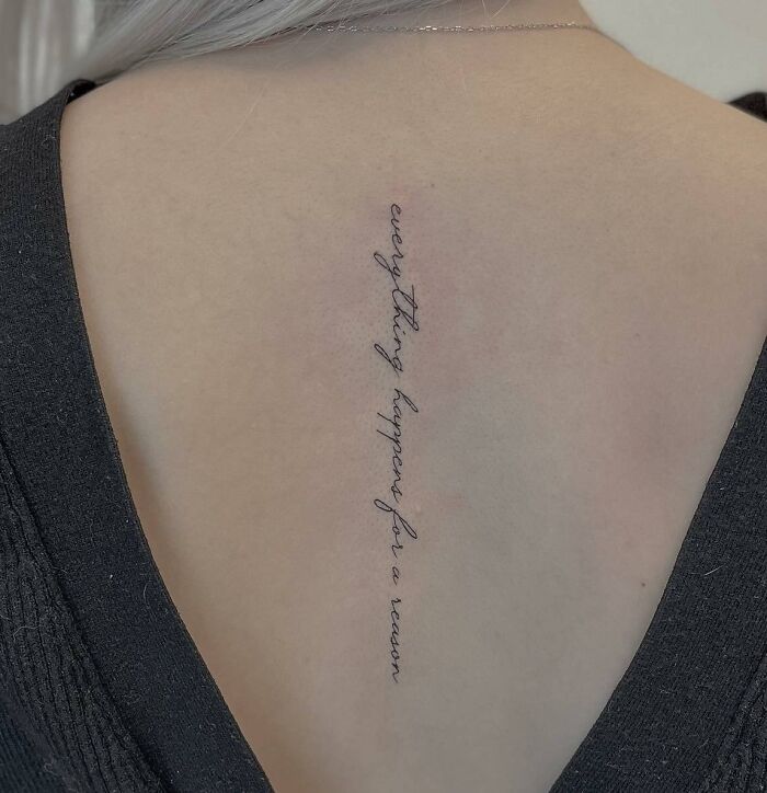 Lettering tattoo on spine