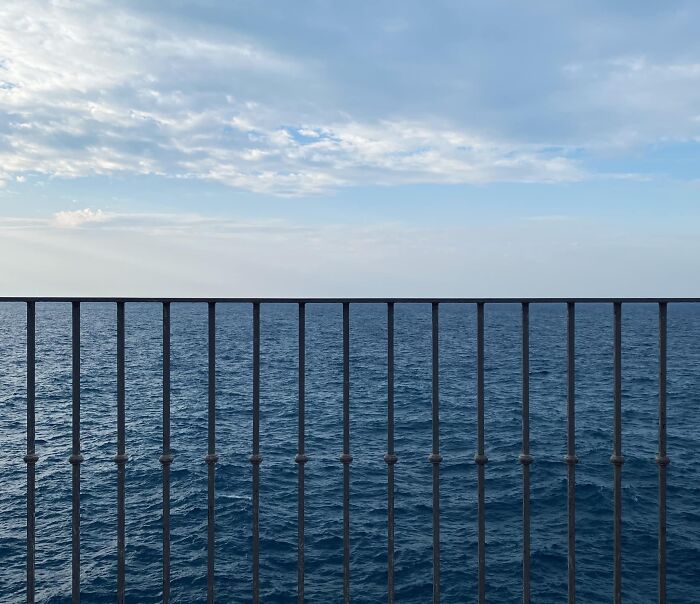 The Horizon, Ocean, And Railing Lined Up