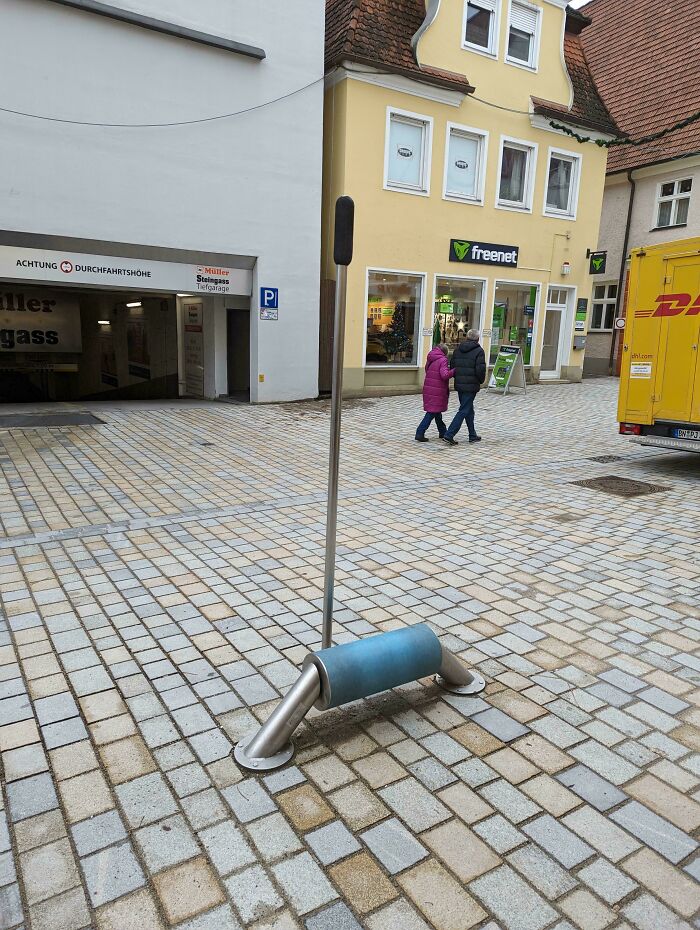Rubbery Roller With Stick Next To It On A Street In Germany