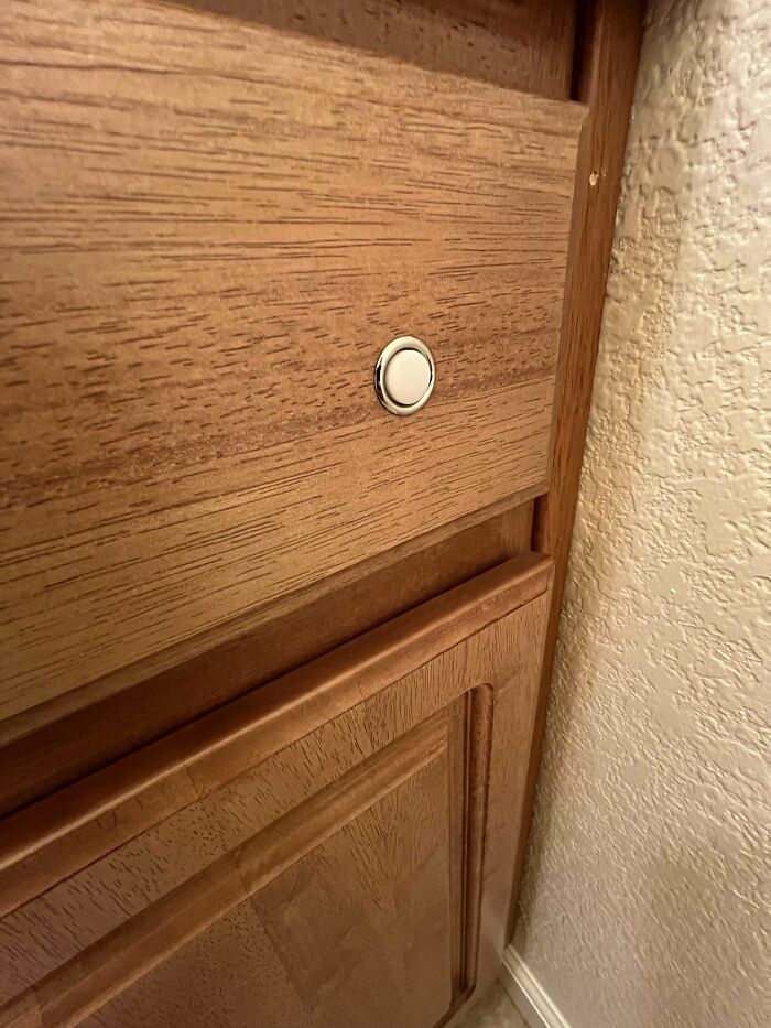 Half Inch Wide, Pushable Button That Is Built Into The Bathroom Vanity. There Are Wires Coming Out The Back Of It, But Nothing Happens When It Is Pushed