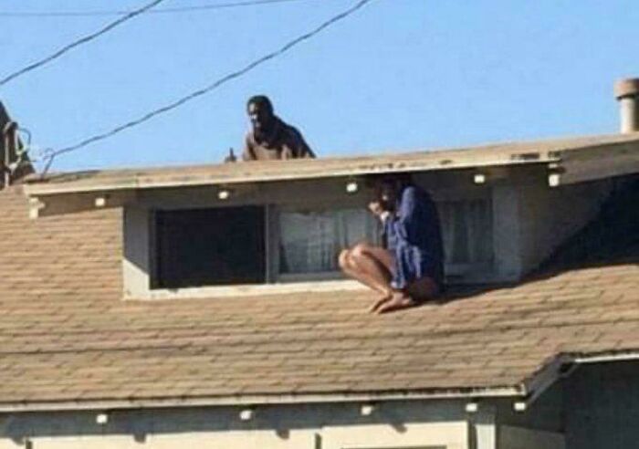 This Terrifying Photo Reveals The Moment A Woman Climbed Onto Her Roof To Hide From Home Intruder Only For Him To Appear Behind Her