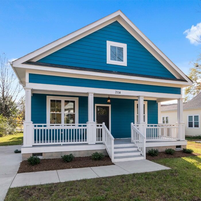 Blue house with porch and white railings