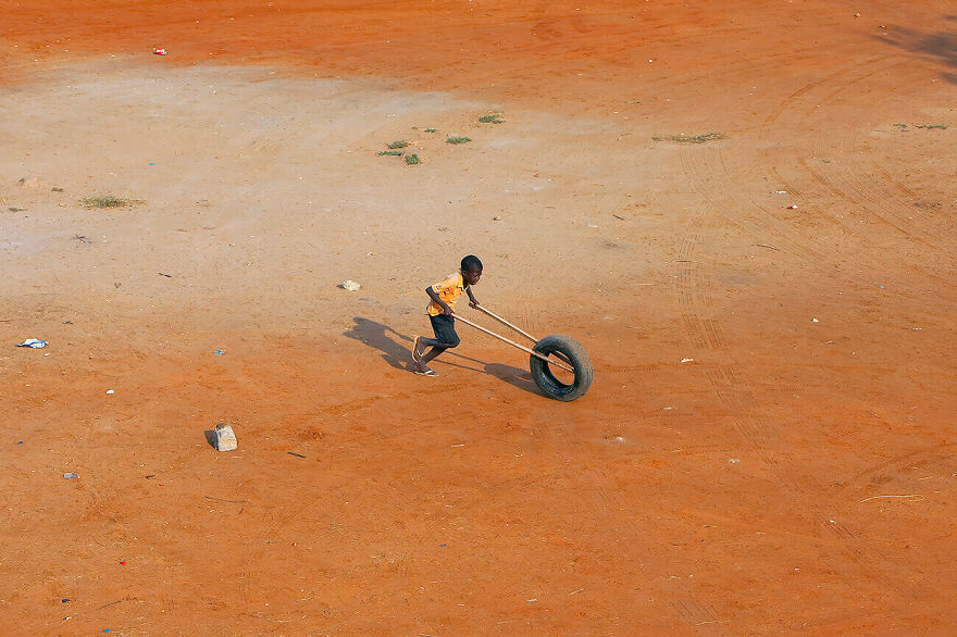 Angolan Boy With Tire From The Series Angola