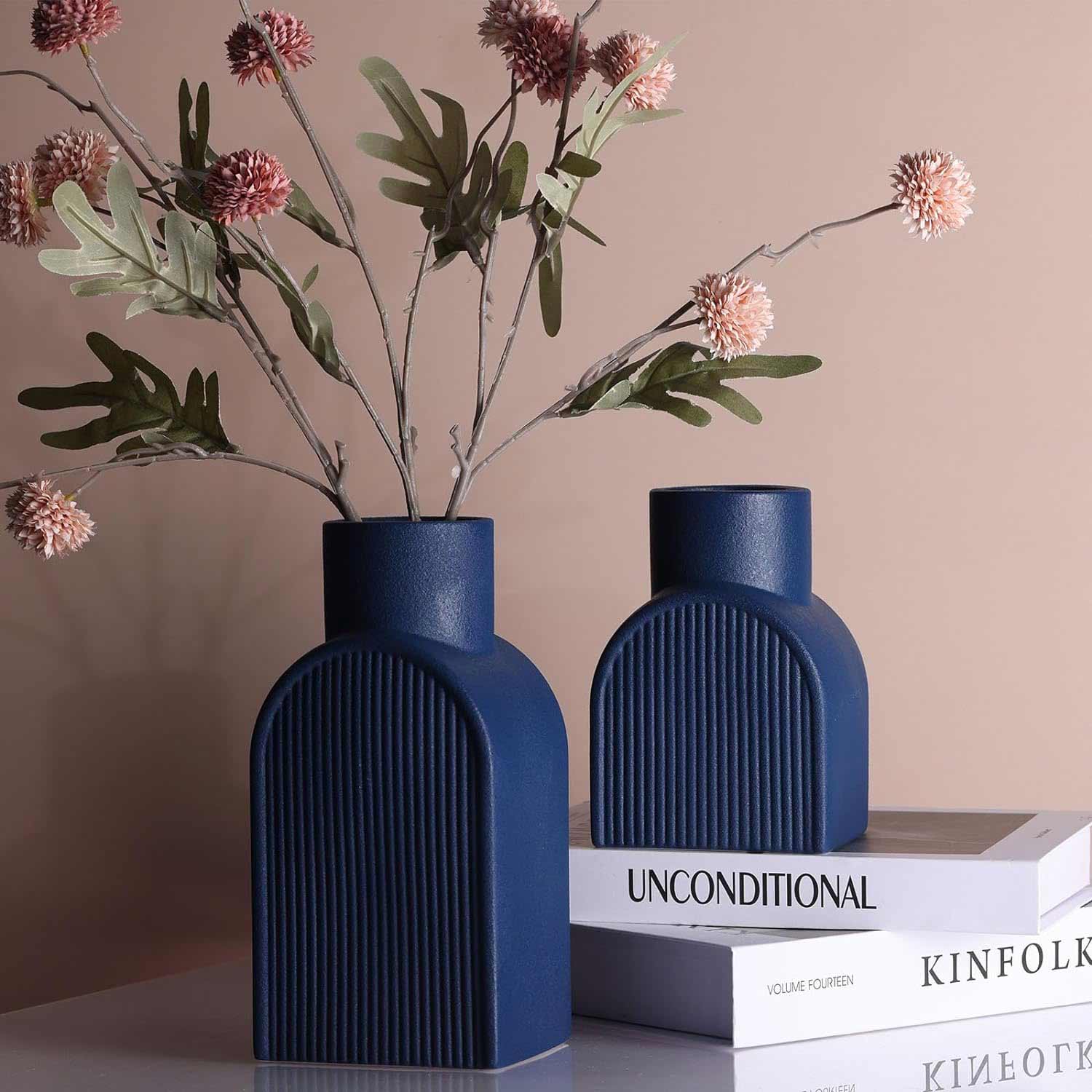 Two dark blue vases and one with flowers