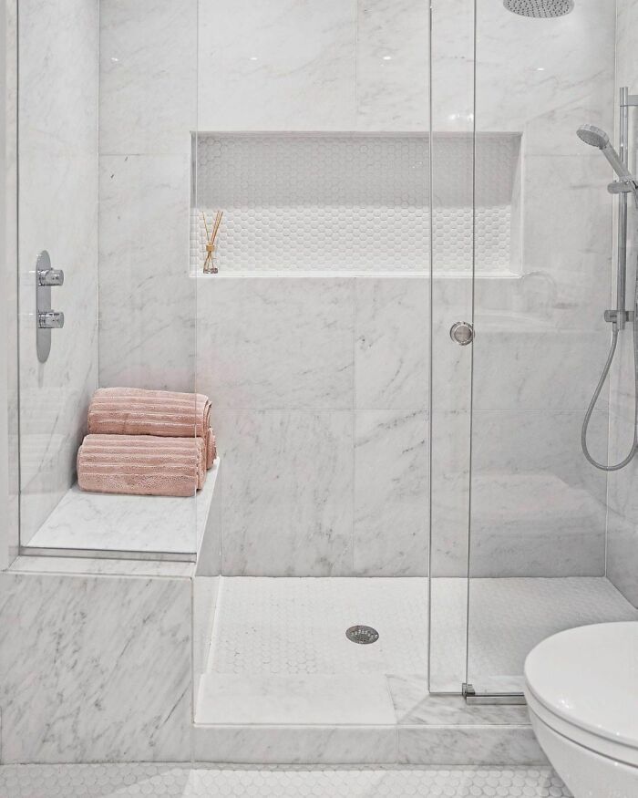 Bright walk-in shower with Calacatta Marble 