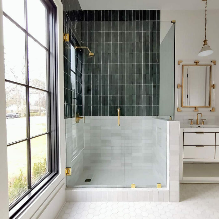 Colorful tiles with brass fixtures in a walk-in shower 