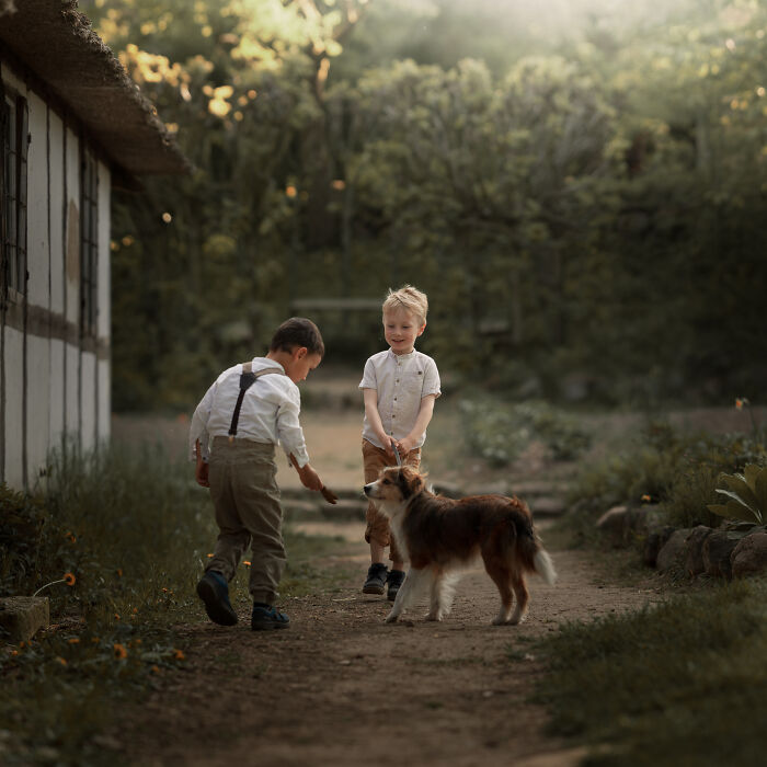 Boys Playing With A Dog