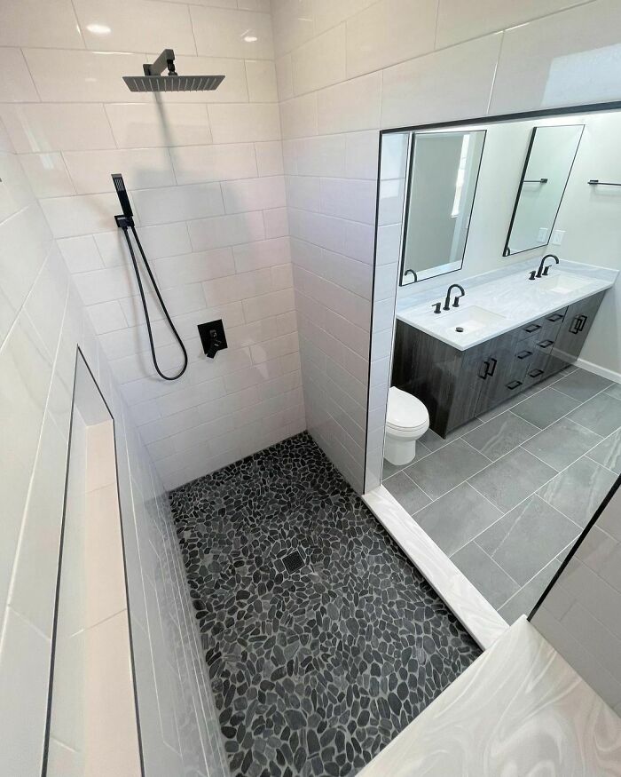 Pebbled floor in a bright walk-in shower 