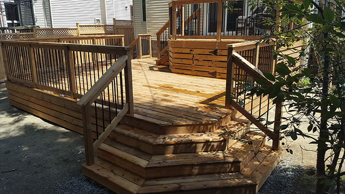 Wooden floating deck with railings.