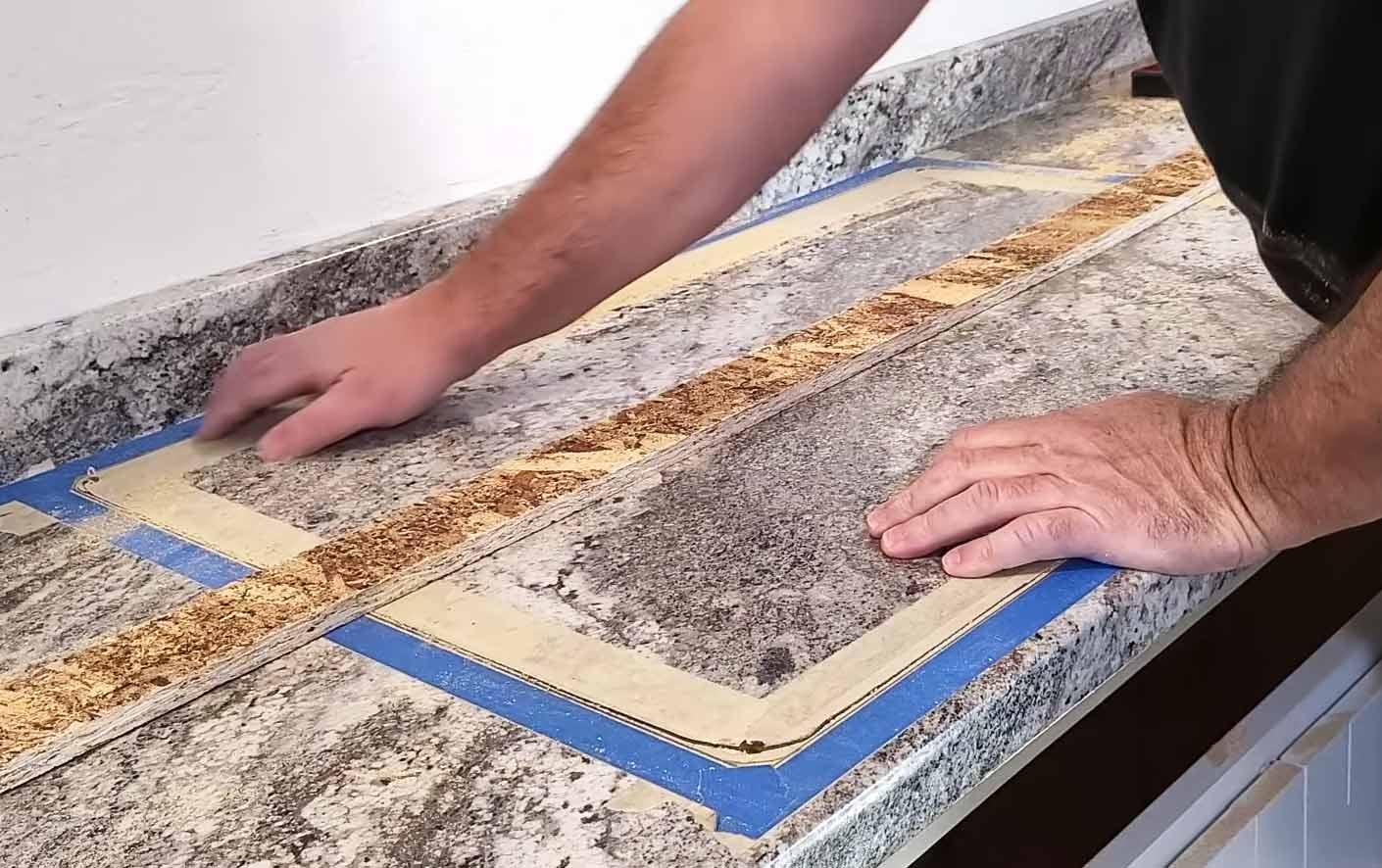 A person installing marble laminate countertop A person installing marble laminate countertop