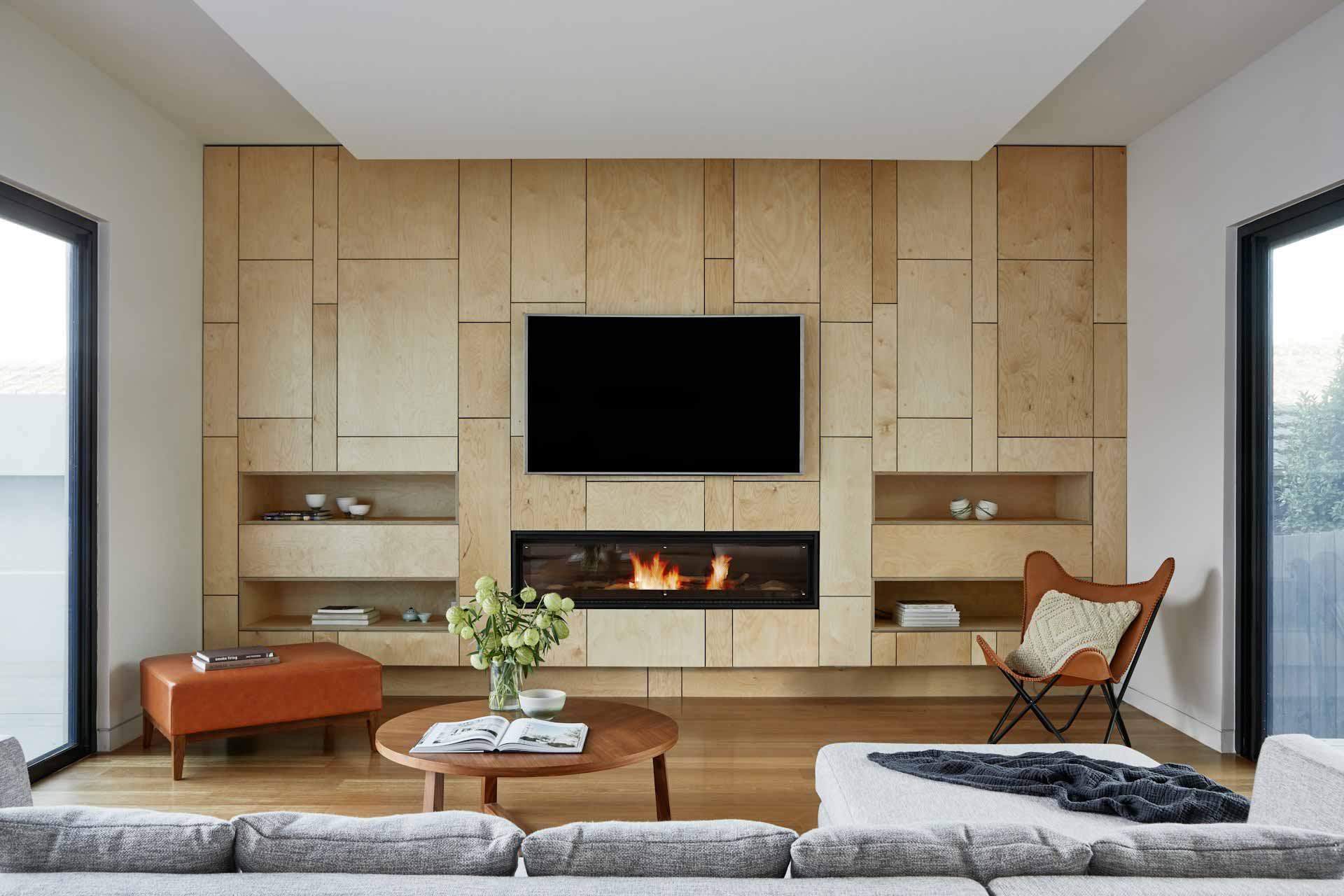 Spacious living room with wood panels wall and flat-screen TV