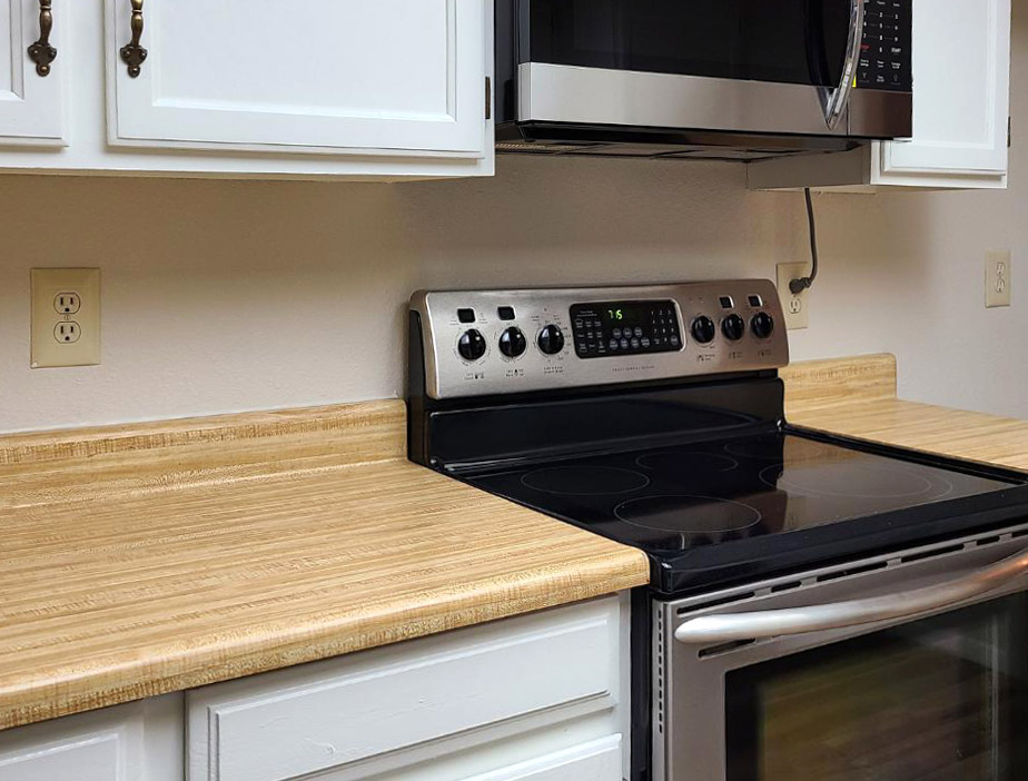 Kitchen with light wood laminate countertop Kitchen with light wood laminate countertop