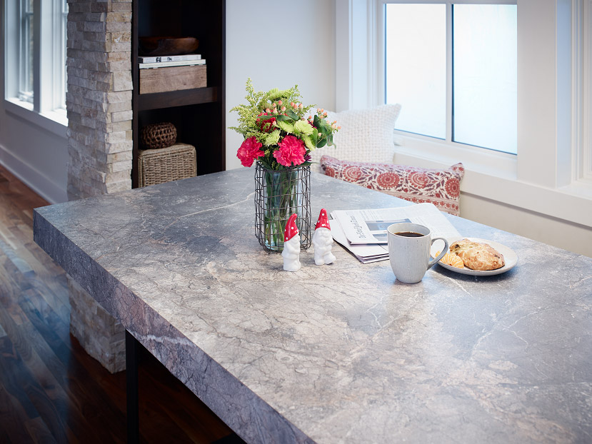 Kitchen table with marble laminate countertop and flowers on top of it