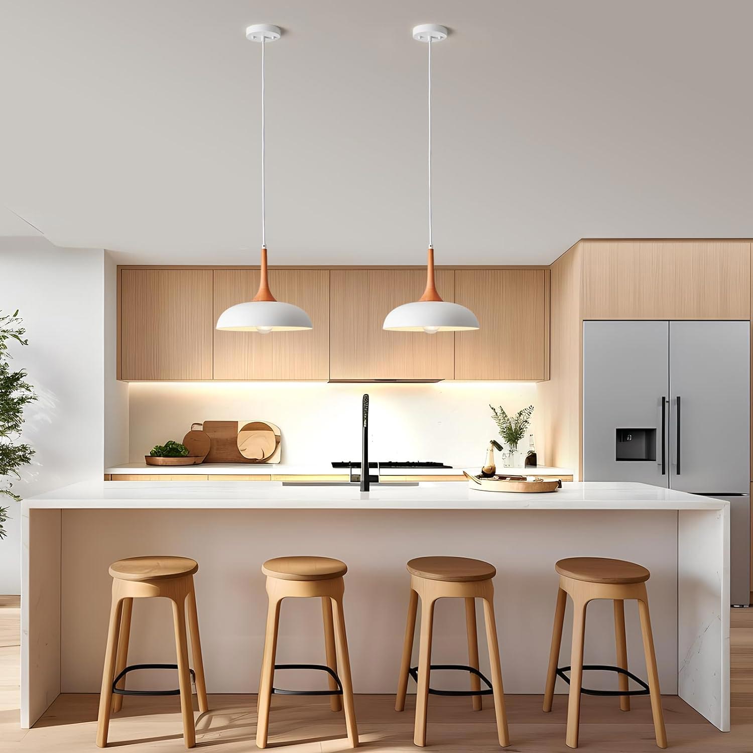 Kitchen with light wooden cabinets, chairs, and two white pendant lamps