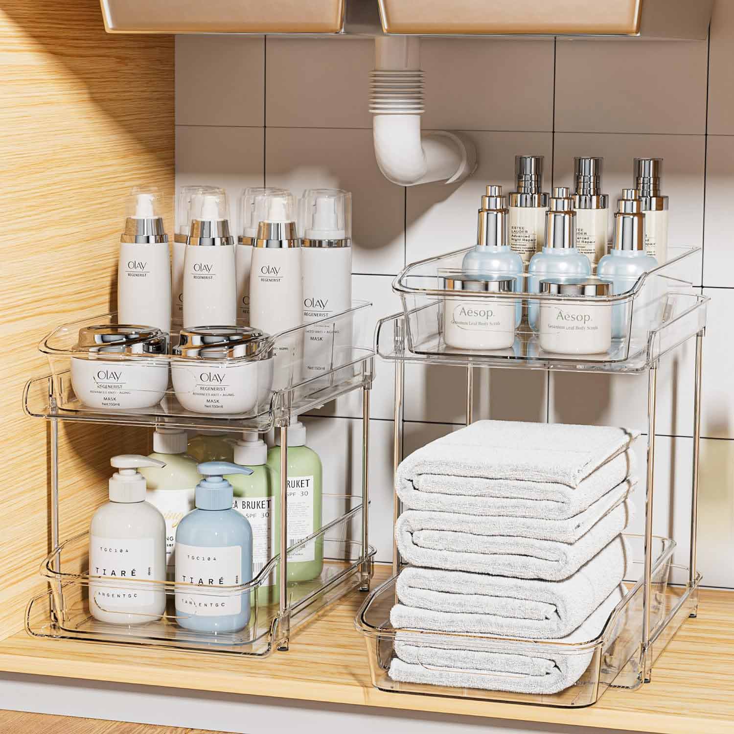 Storage under the sink with white towels and bathroom items