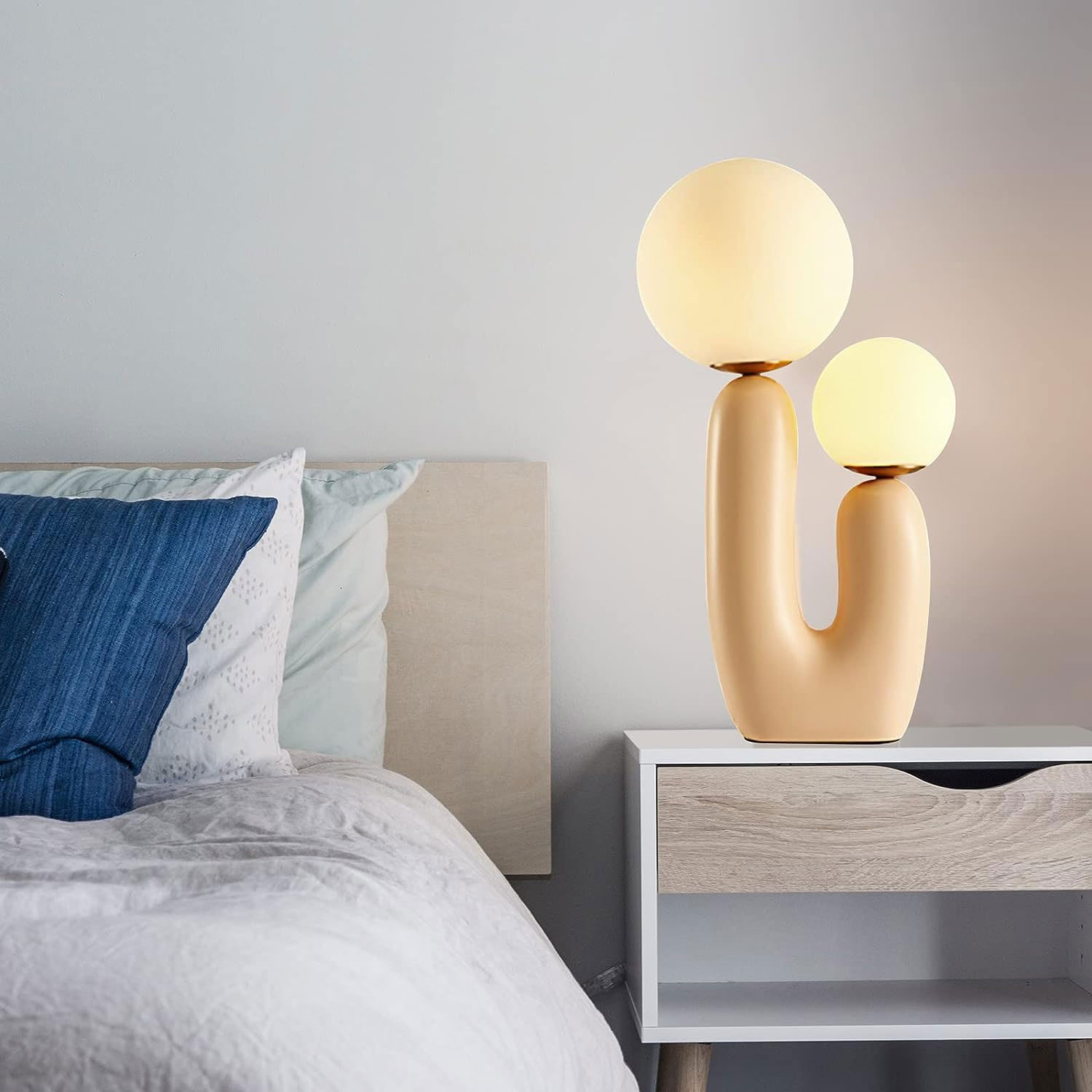 A unique rounded lamp near the bed