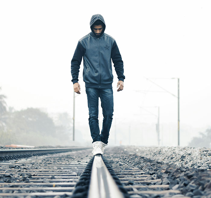 Man Walking and balancing on Train Rail
