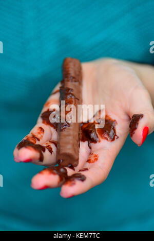 chocolate-bar-melting-in-hand-kem7tc.jpg