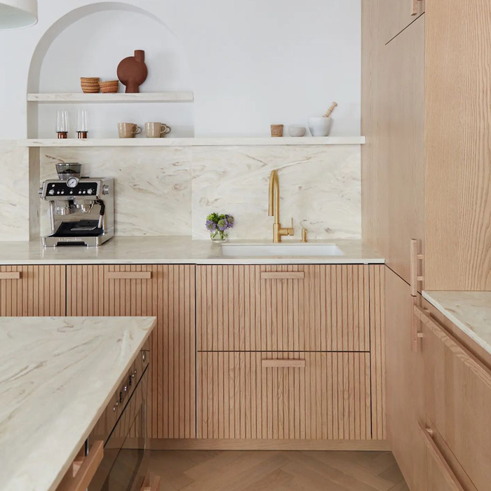 brown wooden kitchen cabinets with white corian countertop