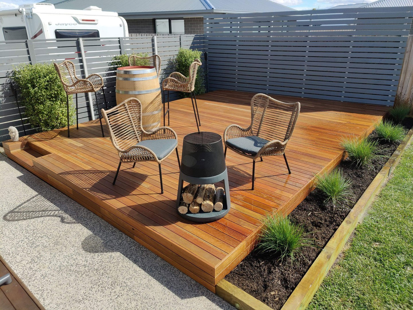 Wooden floating deck with chairs and table.