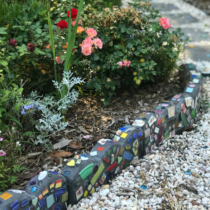 Picture of colorful mosaic tile flower bed edging with colorful flowers