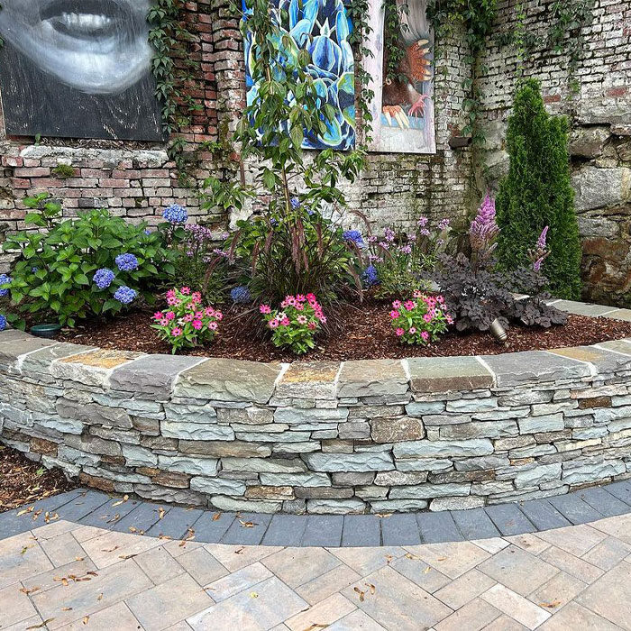 Picture of stone flower bed edging with colorful flowers