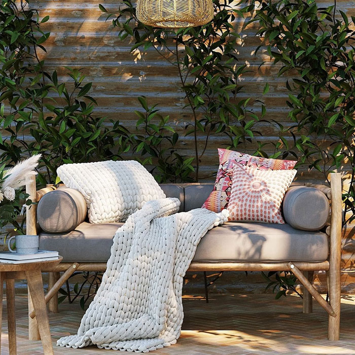 Porch with furniture and pillows with blanket