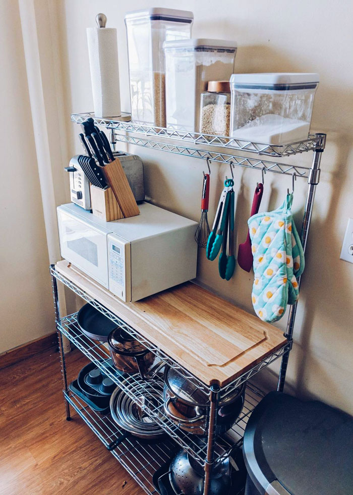 A Brilliant Baker’s Rack That Grants You Extra Counterspace, Perfect Storage Solutions And Even A Removable Cutting Board For Your Micro-Apartment. Who Said Small Can't Be Functional?