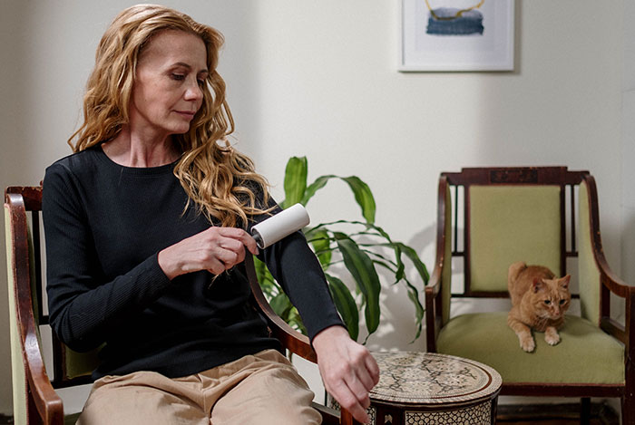 Woman Using Lint Remover