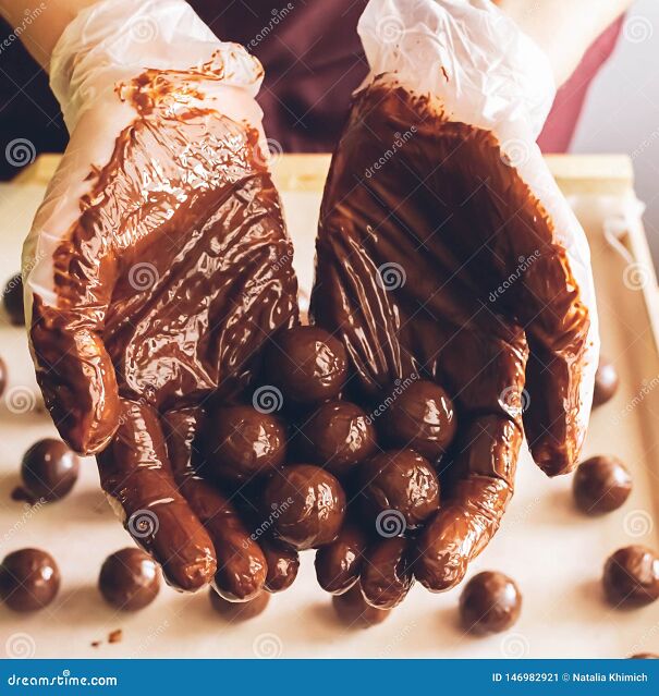 making-handmade-chocolates-round-chocolates-doused-liquid-chocolate-hands-confectioner-chocolatier-selective-146982921.jpg