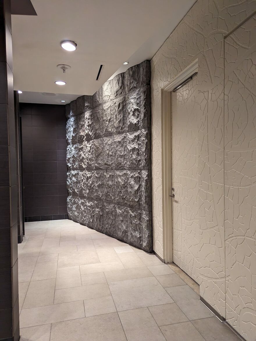 Aria Resort, Las Vegas. Fabric Wrapped Panels Leading To The Restrooms, And Split Faced Stone Wall In Restroom