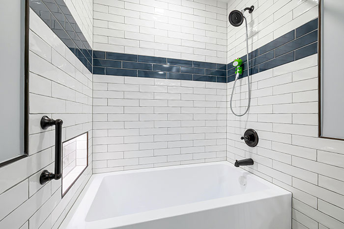 Photo of bathroom with white and dark blue tiles