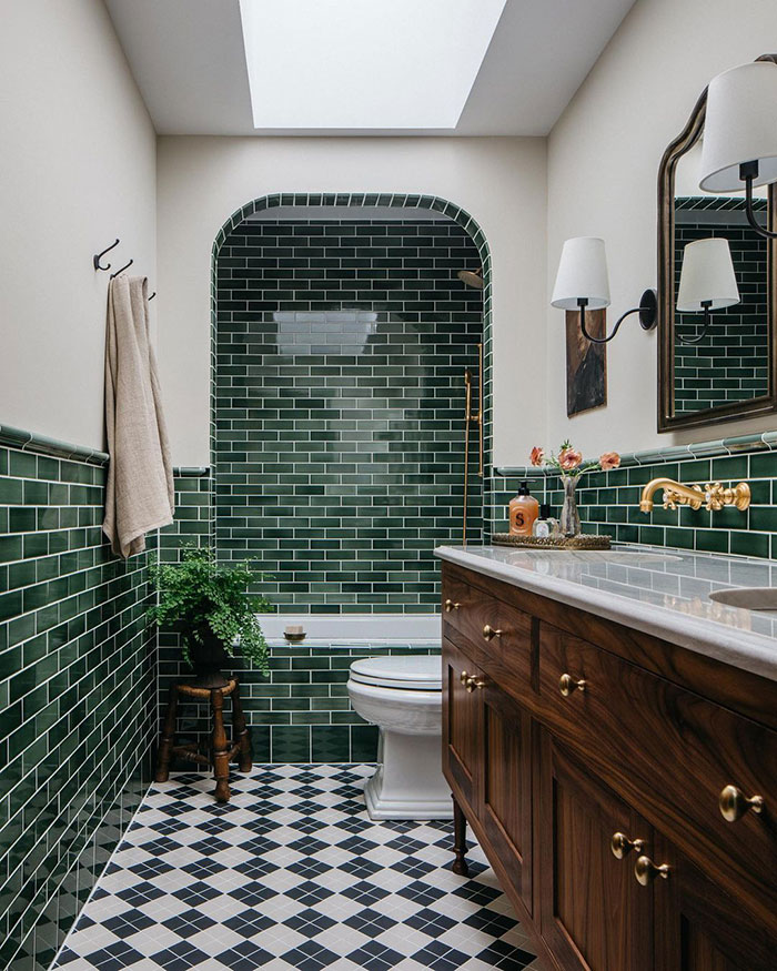 Photography of bathroom with green subway tiles