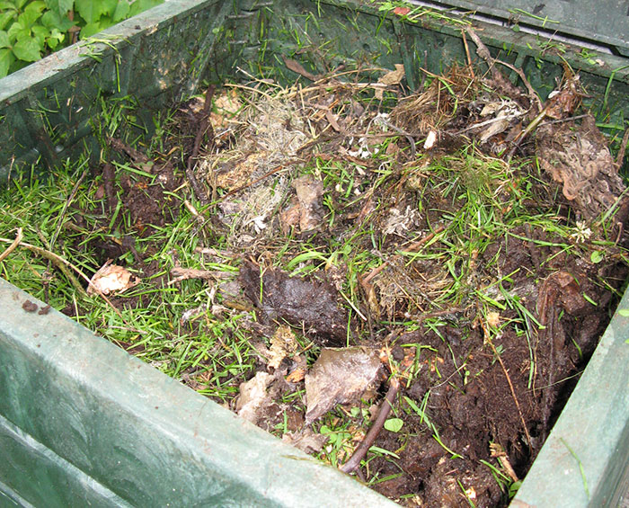 Branches and grass-filled compost box
