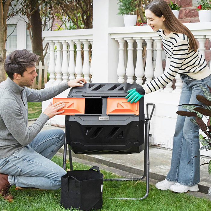Man and woman using a compost box 