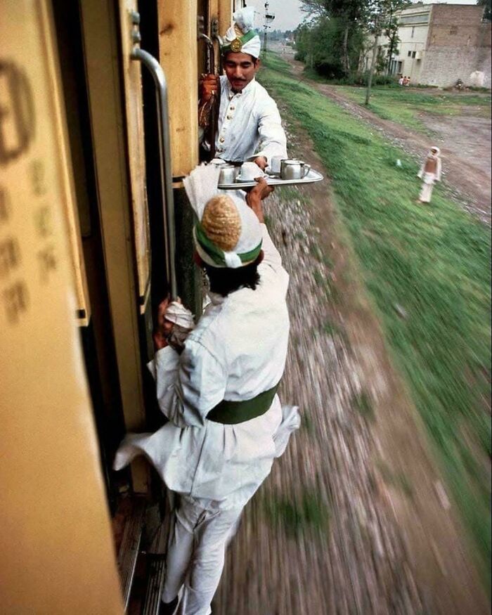 Breakfast Tea Being Passed Between Cars On A Train From Peshawar To Lahore In 1983. Photographed By Steve Mccurry