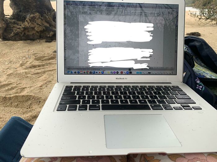 My Mum Is Using Her Laptop In The Rain On The Beach