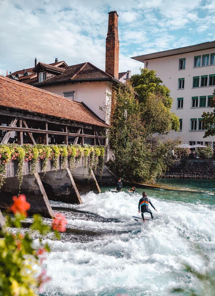 River Surfers In Thun, Switzerland 