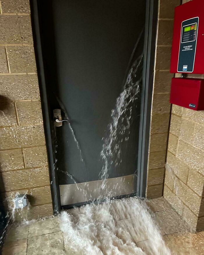 There Is A 7 Feet Wall Of Water From A Burst 5” Pipe, Behind This Inward Swinging Door