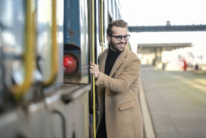 Person standing near the train and smiling
