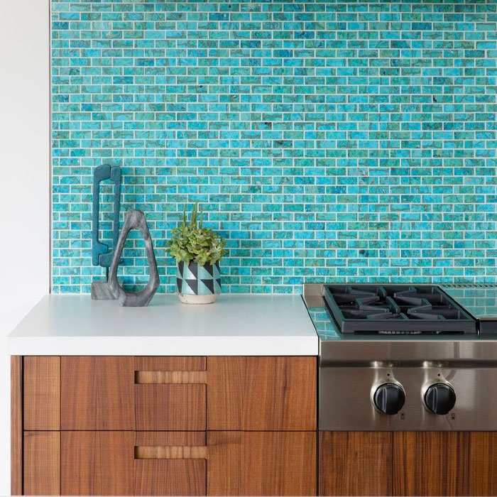 Brown kitchen cabinets near blue tile wall