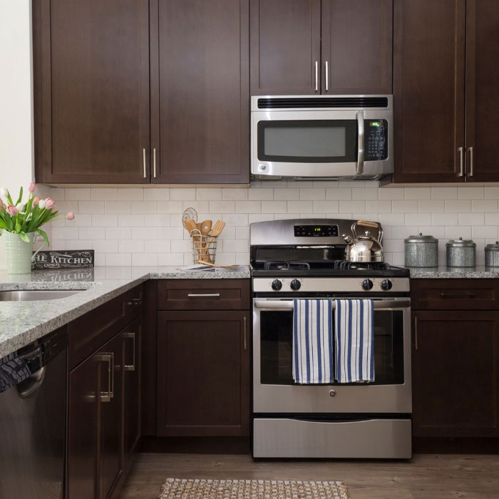Modern espresso kitchen cabinets with white granite countertop