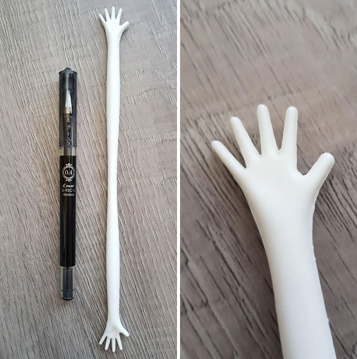 A White Plastic Stick, That Gets Narrower In The Middle, With Small Hands On Both Ends Given As A Wedding Favour/Gift For Guests