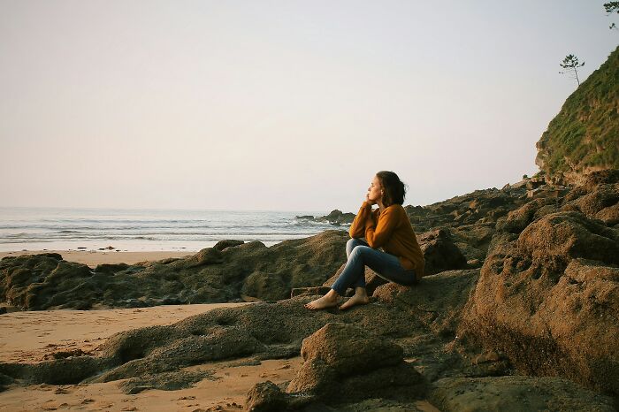 Woman sitting and looking at the sea