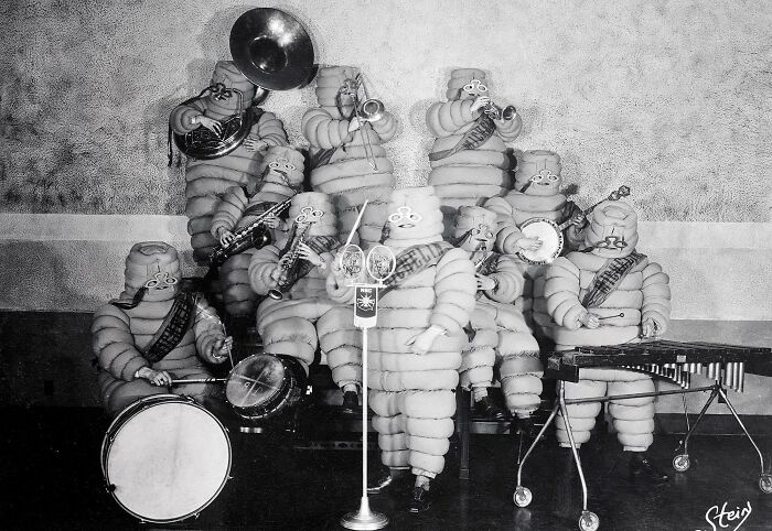 Orchestra Members Dressed In 'Michelin Man' Costumes Open The Inaugural Radio Show Of 'The Michelin Hour'. April 17, 1928