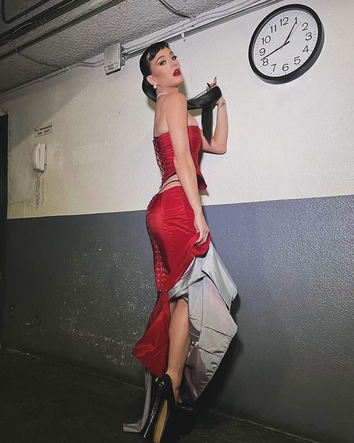 Red dress revealing a thong and butterfly tattoo at the Billboard Women in Music Awards 2024. Red dress revealing a thong and butterfly tattoo at the Billboard Women in Music Awards 2024.