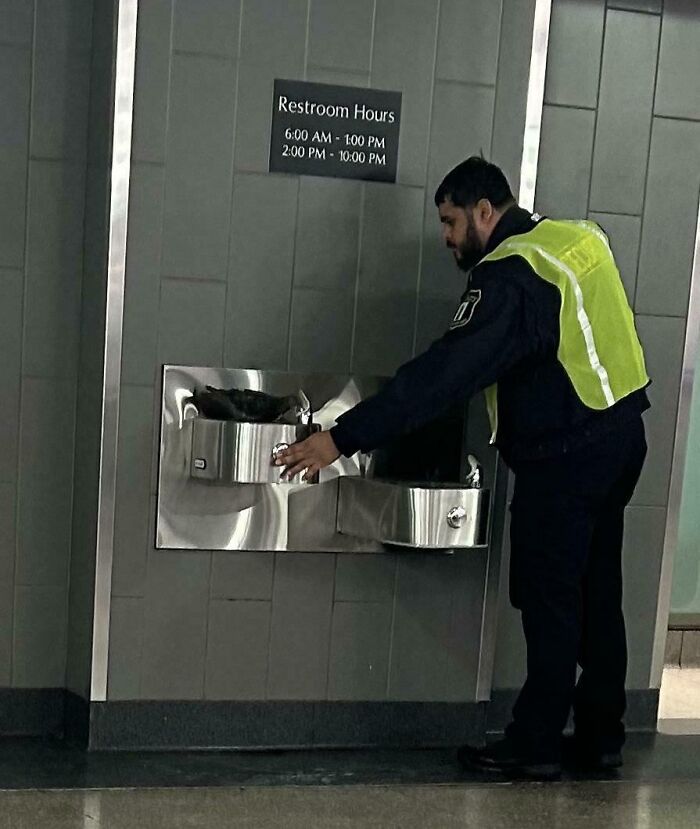 Guard Helps Pigeon To Get Water