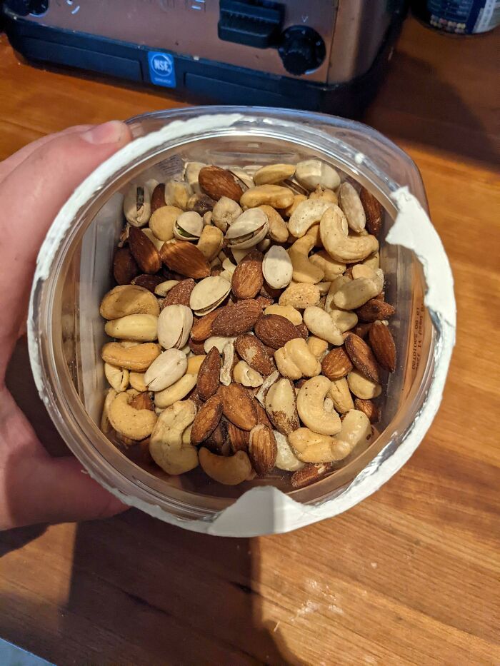 My Wife Adding Pistachios To The Mixed Nut Jar